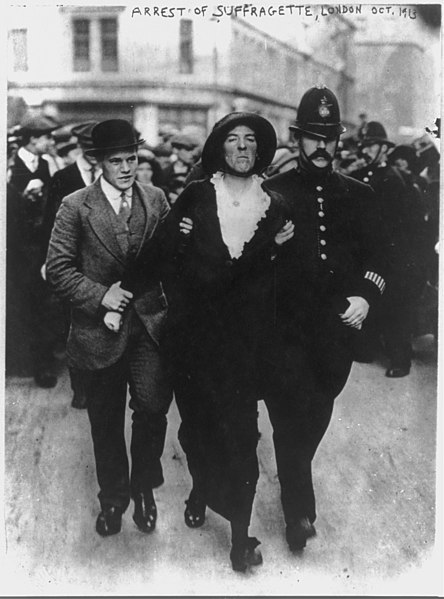 Une suffragette se fait arrêter par deux policiers.